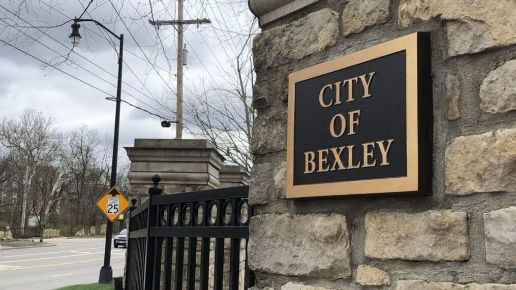 a plaque reads "City of Bexley" on stone column to welcome people into Bexley from the road or sidewalk.